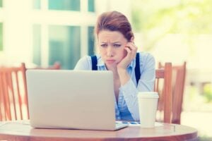 frustrated woman at her laptop