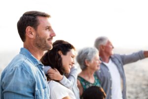 adult children standing with dependent parents and looking at a view