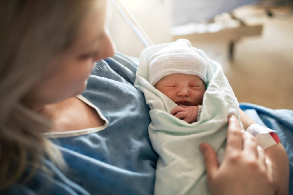 mother holding baby at a hospital