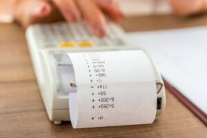 person calculating costs with calculator