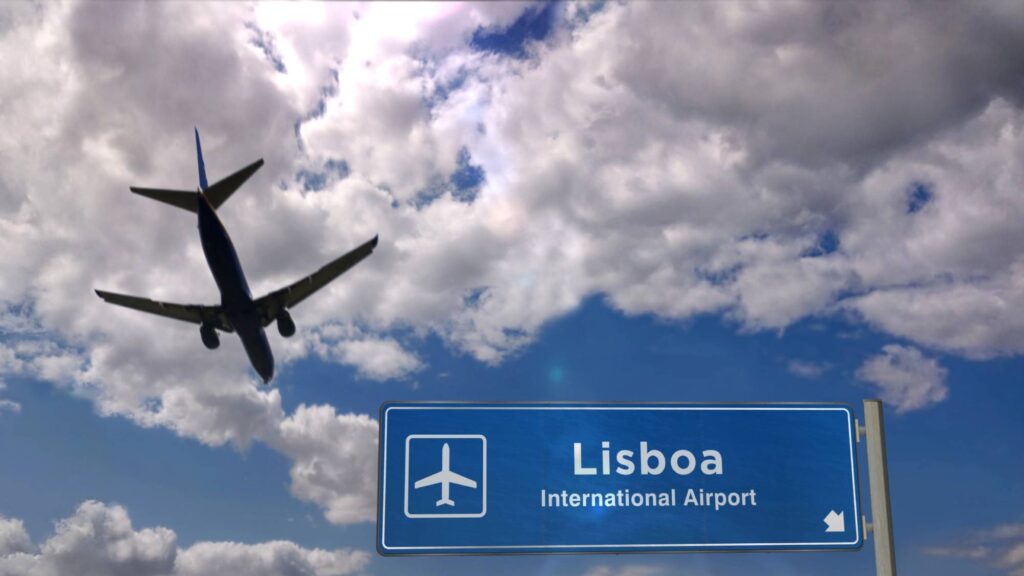 plane flying over lisbon airport sign