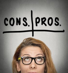 A person wearing black-rimmed glasses looks upwards, with a contemplative expression. Above their head, "CONS." and "PROS." are written, separated by a vertical and horizontal line, suggesting a comparison chart. The background is grey and plain.