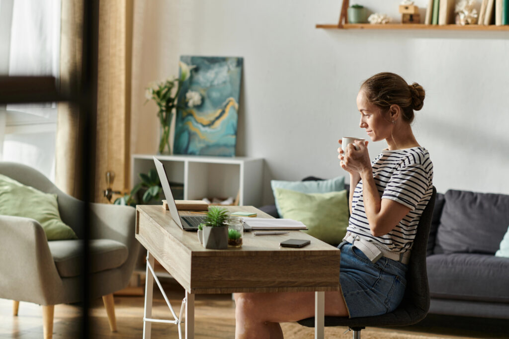 Woman drinking coffee at her desk